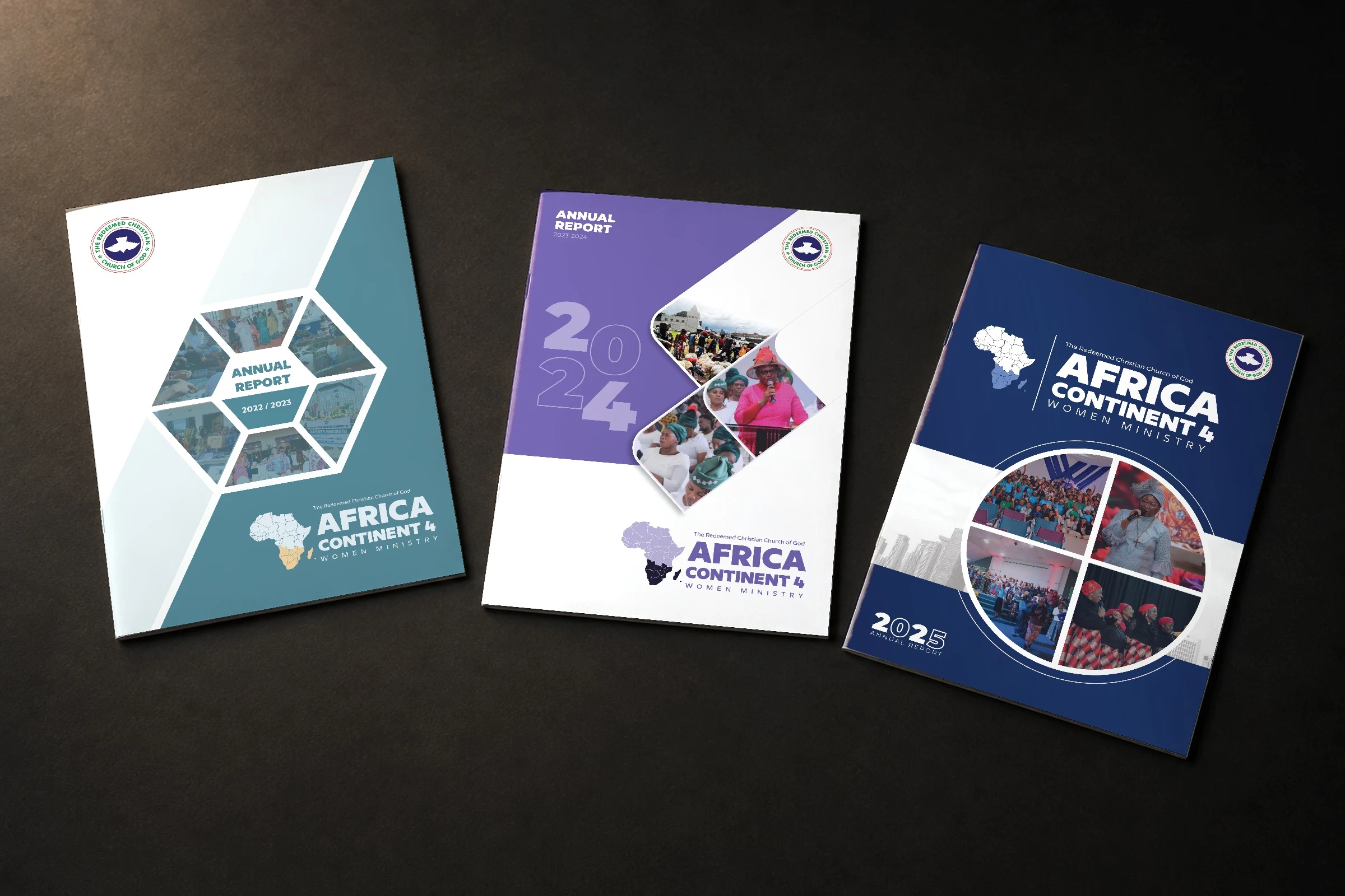 Three printed annual reports for the Women Ministry of the Redeemed Christian Church of God, Africa Continent 4, lying on a dark desk: 2022/2023, 2023/2024 and 2025